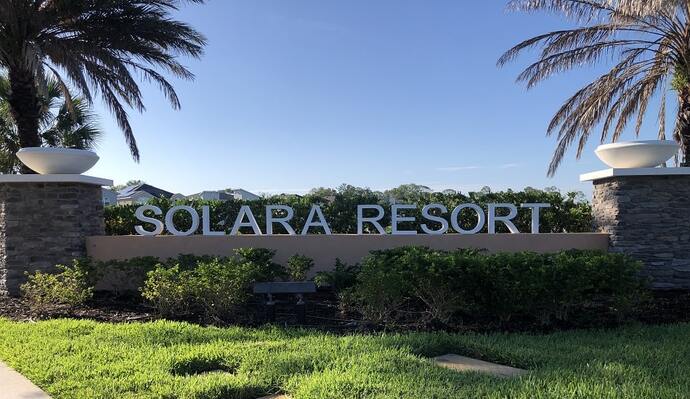 A family enjoying the amenities of Solara Resort Orlando, including a pool, fitness center and indoor and outdoor lounges